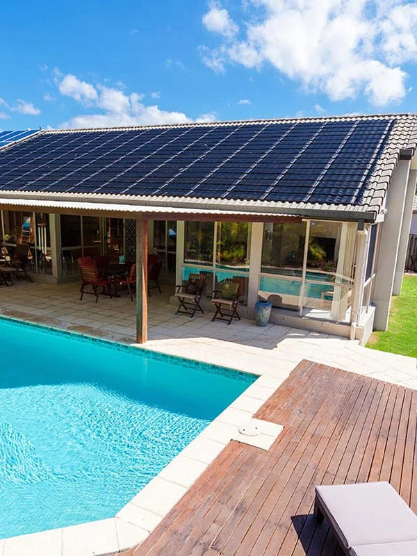A Solar Panel is installed at the rooftop of a building near a pool.